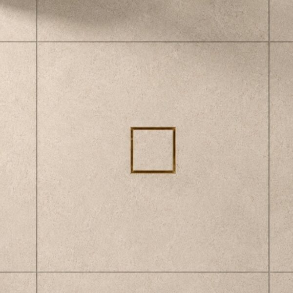 Neston Brushed Brass Square Tile Insert Grate In Tiled Floor Brushed brass square tile insert grate set flush into a large-format tiled floor