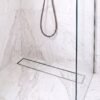 Neston Gun Metal Linear Tile Insert Drain In Marble Shower Gun metal linear tile insert drain installed in a white marble shower