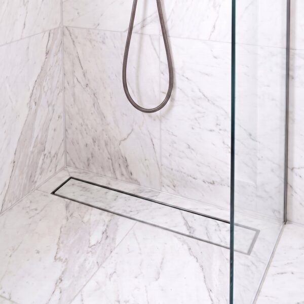 Neston Gun Metal Linear Tile Insert Drain In Marble Shower Gun metal linear tile insert drain installed in a white marble shower